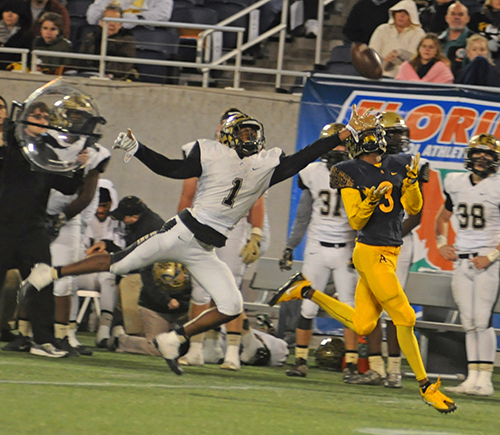 St. Thomas Aquinas receiver Michael Harley hauls in a long pass over Plant defender Whip Philyor on his way to a 62-yard touchdown pass early in the fourth quarter of St. Thomas Aquinas' 46-7 victory over Tampa Plant Dec. 9 in the Class 7A state championship football game at Camping World Stadium in Orlando. Harley's third touchdown reception of the game invoked the FHSAA's mercy rule, setting the game into a running clock.