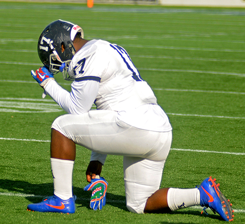 Corey Prince prays before Chaminade-Madonna College Prep's 24-13 loss to Jacksonville Trinity Christian Dec. 10 in the Class 3A state-championship football game.