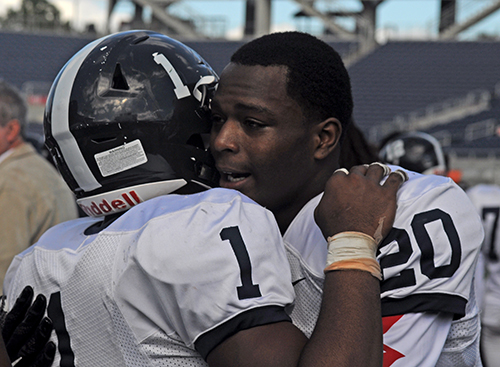 Chaminade-Madonna teammates Cody Watson, left, and Keontra Smith console each other after their 24-13 loss to Jacksonville Trinity Christian Dec. 10 in the Class 3A state championship game at Camping World Stadium.