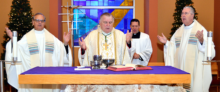 Archbishop Thomas Wenski, center, concelebrates Mass with St. Thomas University leaders. At left is Msgr. Franklyn Casale, university president; at right is Msgr. Terence Hogan, dean of the School of Theology and Ministry.