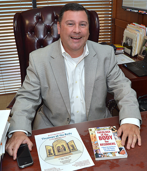 Stephen Colella shows Theology of the Body materials at his office in the archdiocesan Pastoral Center.