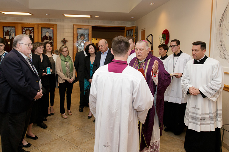 Archbishop Thomas Wenski dedicates the parish hall at Our Lady of Mercy Church in Deerfield Beach in honor of former pastor Father Michael Sullivan, who served there from 1995 to 2003 and has been retired since 2005. Members of Father Sullivan's extended family were present for the occasion.