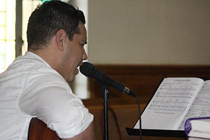Diego Merizalde sings and plays the guitar during a Sunday Mass at St. Joseph Church. Merizalde joined the parish's Hispanic choir three years ago.