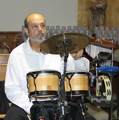 Percussionist Carlos Planos plays with St. Joseph's Hispanic choir during a Sunday Mass.