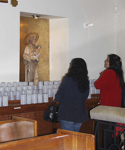 St. Joseph parishioners pray before an image of their patron after a Sunday Mass.
