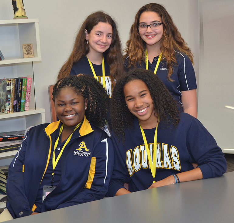 St. Thomas Aquinas High School freshmen took part in  a beach clean-up and serving meals along with the Missionaries of Charity. Seated, from left, are Kenya Warner and Zariah Samaroo. Standing, from left, are Andrea Chacon and Rachel Alston.