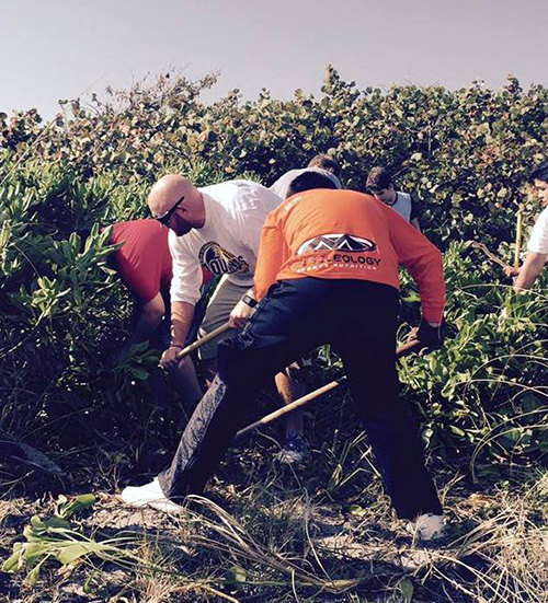 Students and teachers from St. Thomas Aquinas High School clean up John U. Lloyd State Park Nov. 5, 2016. The school's Faith in Action Program is meant to impart meaning and purpose to community service.