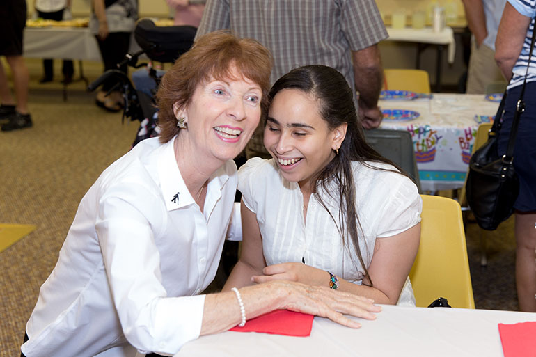 Dolores Hanley McDiarmid, center, a public awareness project manager for Lighthouse of Broward, helped organize an annual Mass and reception Nov. 19 for local persons with disabilities, held at St. Gabriel Church in Pompano Beach. Here she meets with Doris Mancebo of St. Vincent Parish in Margate.