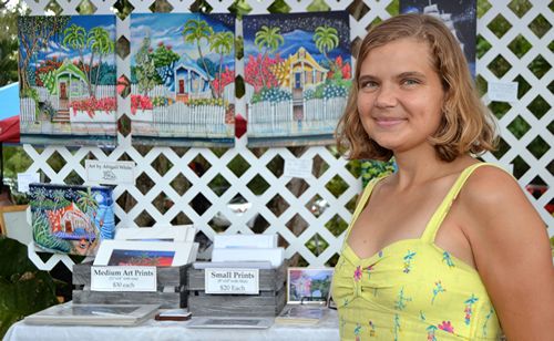 Abigal White of Big Coppitt Key shows her fanciful series of canvases of seashell-like houses during the Art Under the Oaks Festival at San Pedro Church on Plantation Key.