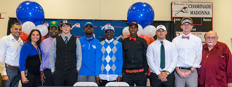 Chaminade-Madonna College Preparatory faculty pose with the student athletes that participated in 2017 National Signing Day. From left: Andre Torres, Raiza Echemendia, Steve Jean-Baptiste, Henry Colombi, Chris Whittaker, Josh Ali, Anthony Johnson, Hunter Bucknam, Brendan Tuttle, and Brother Peter Pontolillo.