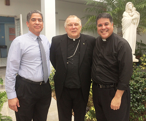 Gerardo Gonzalez, left, Columbus High class of '89 and Campus Ministry director, poses with Archbishop Thomas Wenski and his brother, Father Miguel Gonzalez, Columbus class of '86 and pastor of St. John Vianney Parish in Orlando.