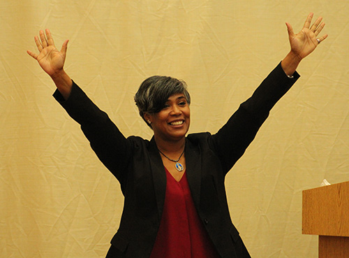 Lydia Ocasio-Stoutenburg, speaker and organizer of God's Perfect Design retreat, raises her hands imitating her son's praise when he saw the image of Our Lady of Perpetual Help.