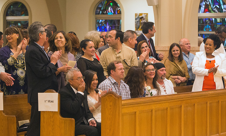 Couples married 25 years stand to be recognized during the annual wedding anniversaries Mass at St. Mary Cathedral Feb. 11, 2017.