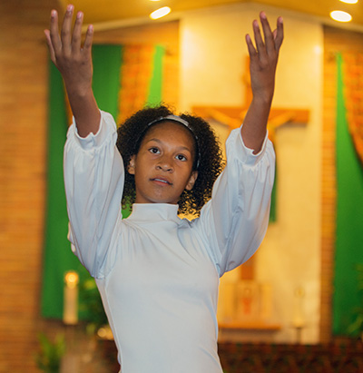 Carianne Cover, 13, a member of Holy Redeemer youth group, dances at the first night of the annual black Catholic pre-Lent revival, led this year by Redemptorist Father Maurice Nutt.