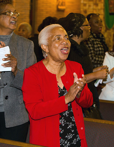 Wilhelmina King claps her hands during the first night of the annual black Catholic pre-Lent revival, held Feb. 12-15.