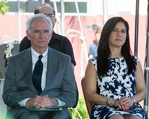 Longtime parishioner Pat Collins, left, sits on the stage along with co-commentator Teri Howard, during the 75th anniversary Mass for St. Joseph Parish, Miami Beach.