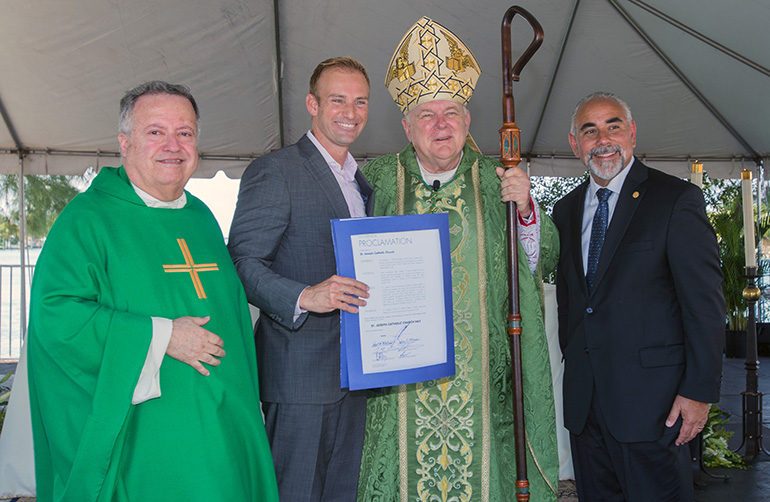 Father Juan Sosa, left, St. Joseph's pastor, poses with Miami Beach Commissioner Michael Grieco, Archbishop Thomas Wenski and Miami Beach City Manager Jimmy Morales, far right, a St. Joseph School graduate. Grieco and Morales presented a proclamation from the City of Miami Beach naming Feb. 12, 2017 "St. Joseph Catholic Church Day" in honor of the parish's 75th anniversary.