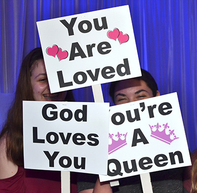 Students at St. Bonaventure School show their placards during the Night to Shine Prom at St. Bonaventure Church in Davie.