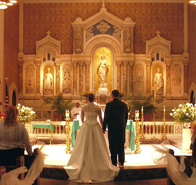 In this file photo, a couple marries at Gesu Church in downtown Miami. While having the ethereal white dress, the stretch limo, the multi-tiered cake, ocean-view venue and destination honeymoon adds to the celebration of marriage, it should not be the sole focus of the wedding. The focus should be on lifelong marriage and the vows made in the church before God.