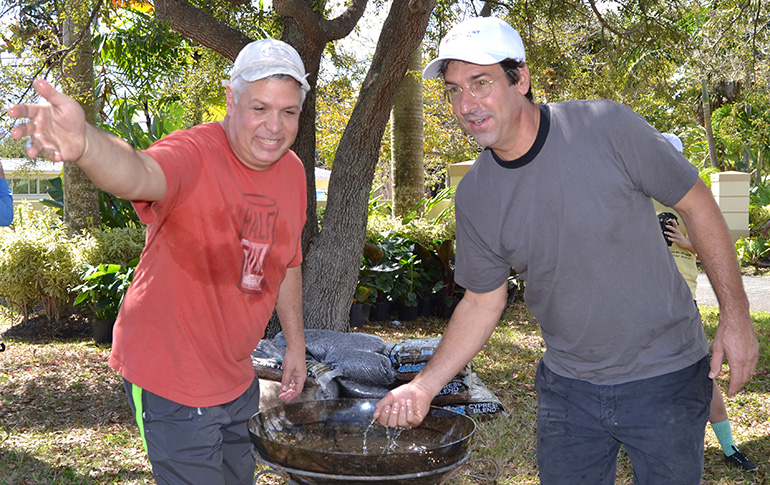 Michael DeFerrari, left, and Tony Buzone bless the ground of the new Prayer Labyrinth.