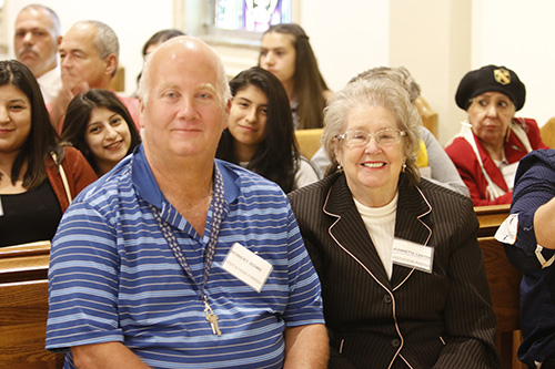 Robert Rowe, a catechumen from Visitation Parish in North Miami, sits with his godparent, Jeannette Carter, before the start of the first Rite of Election ceremony March 5. He is one of about 550 people who will be baptized and join the Catholic Church at this year's Easter Vigil.