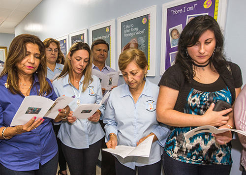 Respect Life volunteers pray during the dedication of the new North Dade Pregnancy Help Center in Miami Gardens.
