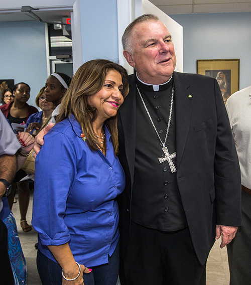 Archbishop Thomas Wenski poses for a photo with a respect life volunteer at the North Dade Pregnancy Help Center.