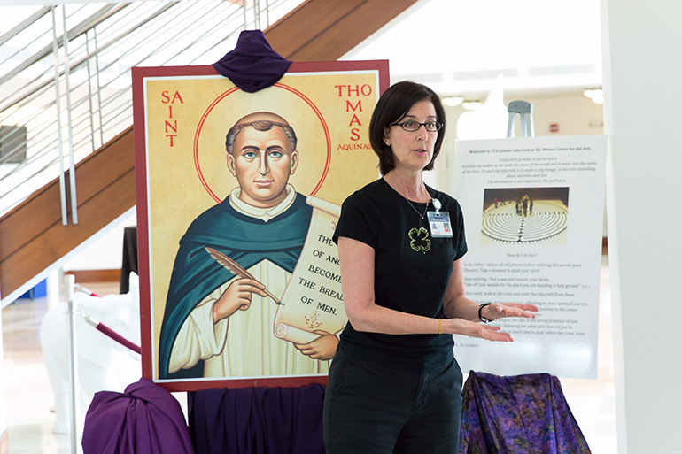 St. Thomas Aquinas High School theology teacher Marianne Jones talks with students as they experience a “Lenten Labyrinth” faith walk and prayer experience March 17 at the high school in Fort Lauderdale as part of the school’s campus ministry and liturgical ministry Lenten programming. The custom-built labyrinth, which was surrounded by reproductions of ancient icons, was located at the Bienes Center for the Arts at St. Thomas Aquinas High.