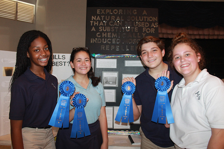 The eighth-grade team composed of, from left, Marjdole Jadotte, Lilian Ang, Brian Cervoni and Emily Nortmann will represent Annunciation School at the Florida State Science and Engineering Fair. Their project focused on the effectiveness of mosquito repellents made from plants and herbs.