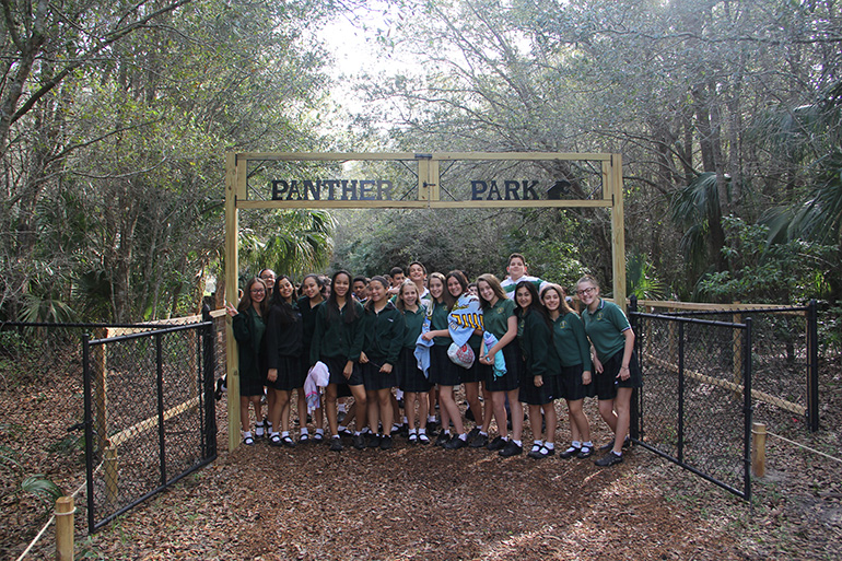 Mary Help of Christians School students stand at the entrance to their newly-opened Panther Park.