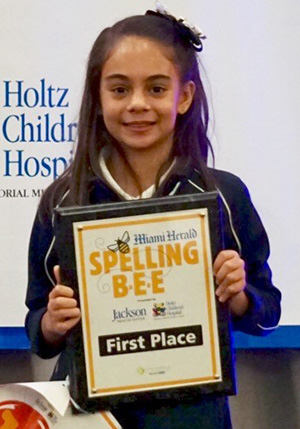 St. Bonaventure fifth grader Simone Kaplan poses with her first place certificate after the Broward County spelling bee. She will travel to Washington at the end of May to compete in the Scripps National Spelling Bee.
