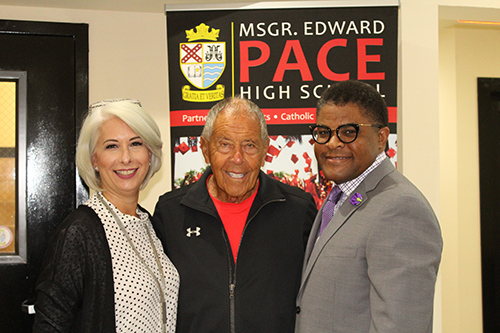 Msgr. Edward Pace High Principal Ana Garcia poses with pro tennis coach Nick Bollettieri, center, and former Opa-Locka police chief James Wright, who arranged the hall-of-famer's visit to the school.