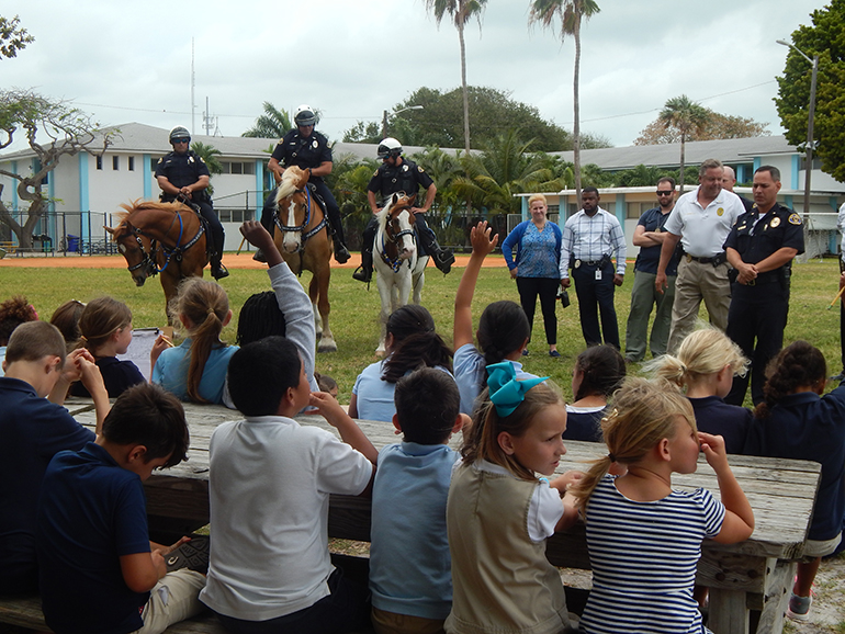 Second graders at the Basilica School of St. Mary Star of the Sea in Key West ask questions of representatives of the Key West Police Department April 21.