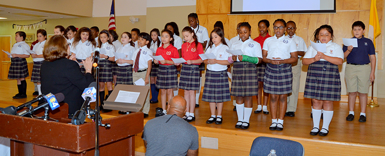 Students of St. Andrew School lead in singing "Let There Be Peace on Earth."