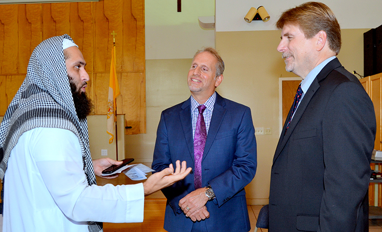 Imam Izhar Khan discusses a religious point with Rabbi Bradd Boxman, center, and Pastor Randal Cutter.