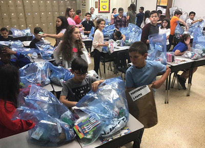St. Brendan School fifth graders work together to pack "blessing bags" for the Miami Rescue Mission.
