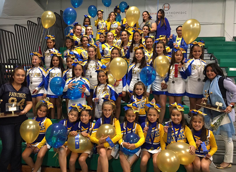 Sts. Peter and Paul primary, junior varsity and varsity teams pose for a group photo with their coaches after the All Catholic Conference cheer competition April 8.