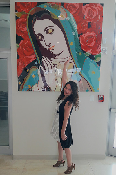 Let's Talk blogger Blanca Morales poses in front of one of the artworks at Our Lady of Guadalupe Church in Doral.