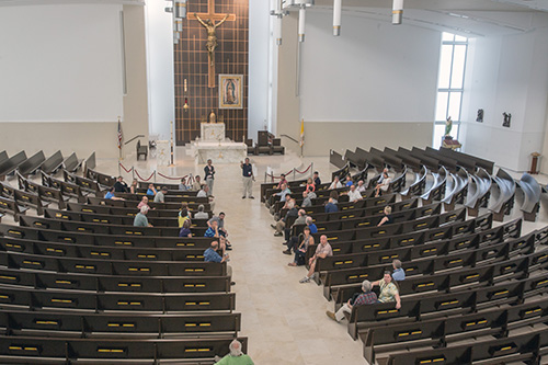 David Prada, senior director of Building and Property for the Archdiocese of Miami, tells fellow members of the Conference for Catholic Facility Management about Our Lady of Guadalupe Church in Doral during a site visit on the last day of their national meeting, which was hosted by the Archdiocese of Miami. The group also visited the Innovation Center at St. Brendan High School in Miami.