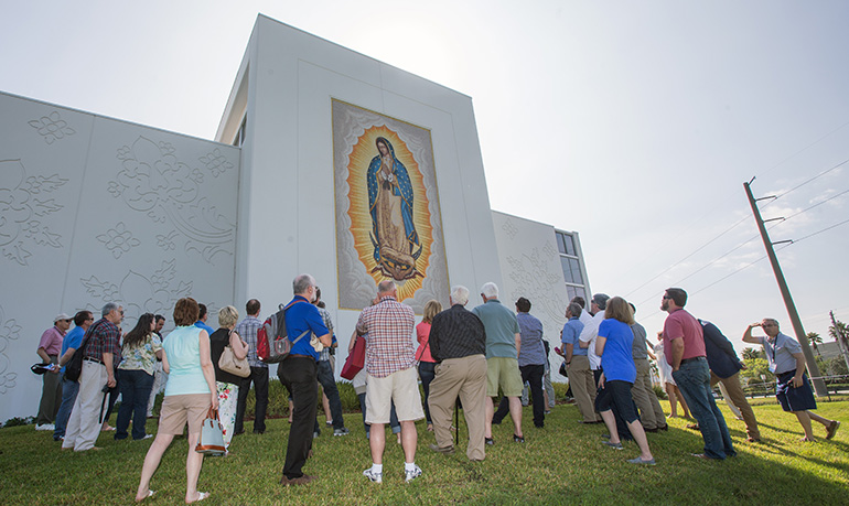 Members of the Conference for Catholic Facility Management view the image on the rear wall of Our Lady of Guadalupe Church in Doral during a site visit on the last day of their national meeting, which was hosted by the Archdiocese of Miami. The group also visited the Innovation Center at St. Brendan High School in Miami.