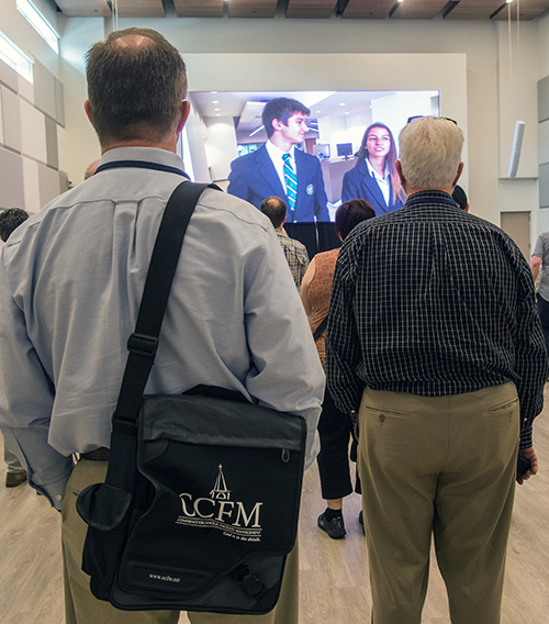 Members of the Conference for Catholic Facility Management watch a video presentation in the Innovation Center at St. Brendan High School in Miami. The onsite visit to St. Brendan, as well as Our Lady of Guadalupe Church in Doral, came at the conclusion of the CCFM's annual meeting, held April 24-26, and hosted by the Archdiocese of Miami.