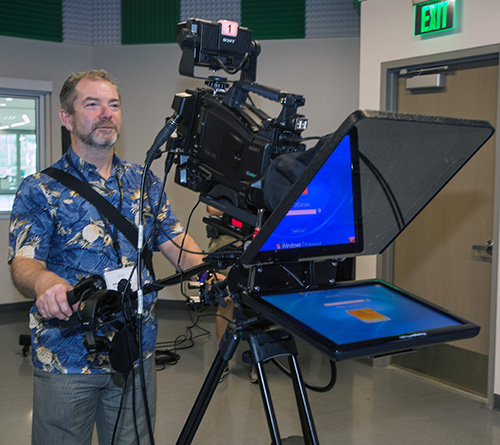 Adam Strugala of Superior, Wisconsin, tries out one of the television cameras in the TV studio inside St. Brendan High School's Innovation Center. Members of the Conference for Catholic Facility Management toured the school, as well as Our Lady of Guadalupe Church in Doral, at the conclusion of their annual meeting, held April 24-26, and hosted by the Archdiocese of Miami.