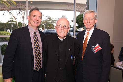 John Buckley, Father Anthony Mulderry, pastor of St. Gabriel Church in Pompano Beach, and Albert Massey pose for a photo before the banquet that followed the annual Red Mass of the St. Thomas More Society of South Florida.