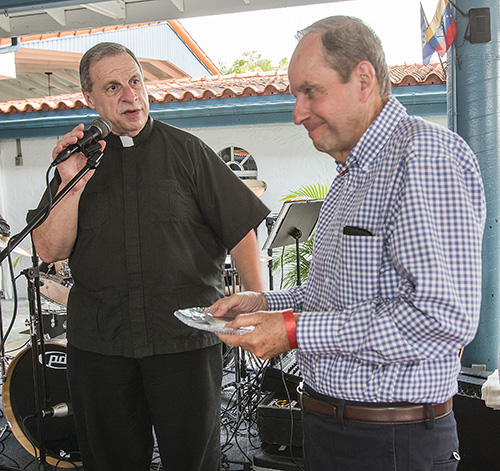 Msgr. Pablo Navarro presents a token of recognition to Alfredo Romagosa, a member of the School of Ministry's first graduating class in 1979. He and his wife, Margarita Romagosa, have been  collaborators in the Office of Lay Ministry ever since.