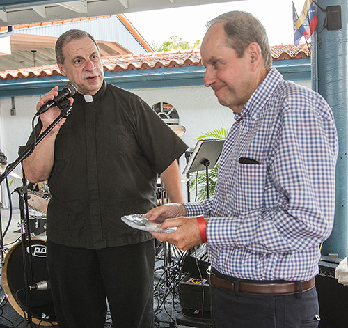 Mons. Pablo Navarro presenta una muestra de reconocimiento a Alfredo Romagosa, miembro de la primera clase de graduados de la Escuela de Ministerio, en 1979. Desde entonces, él y su esposa, Margarita Romagosa han colaborado con la Oficina de Ministerios Laicos.