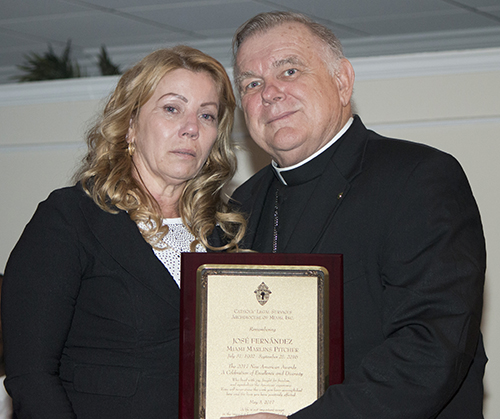 A tearful Maritza Gomez, mother of the late Marlins pitcher Jose Fernandez, receives his posthumous New American Award from Archbishop Thomas Wenski.