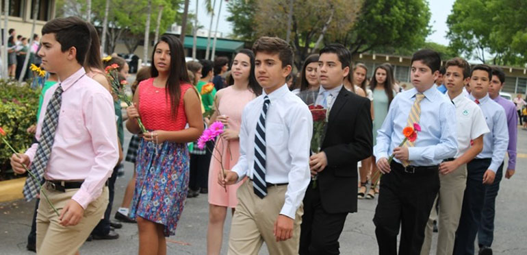 Eighth-grade students from St. Kevin School, fresh from their own confirmation, process to the church carrying flowers for the May crowning.