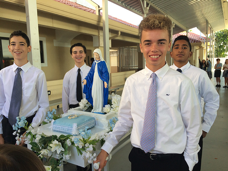 Eighth graders from St. Bonaventure School carry the image of Mary during the procession around the perimeter of the church and school.