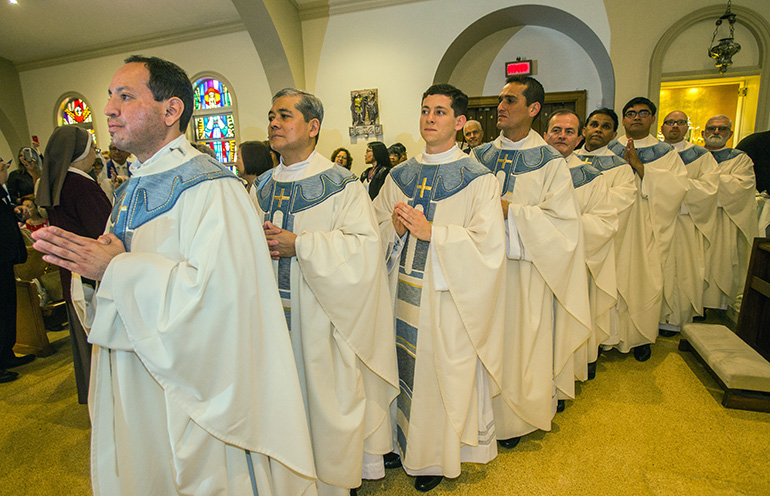 The nine newly-ordained priests wait to take their place around the altar of St. Mary Cathedral for the Liturgy of the Eucharist. From left: Father Luis Flores, Father Edgardo "Gary" De Los Santos, Father Alexander Rivera, Father Juan Carlos Salazar, Father Oswaldo Agudelo, Father Mathew Padickal Thomas, Father James Arriola, Father Luis Pavon and Father Joseph Maalouf.