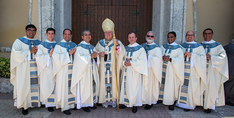 Archbishop Thomas Wenski ordained nine men to the priesthood, the largest archdiocesan class in decades, on the 100th anniversary of the apparitions at Fatima, May 13 at St. Mary Cathedral. From left: Father James Arriola, Father Alexander Rivera, Father Luis Flores, Father Edgardo "Gary" De Los Santos, the archbishop, Father Oswaldo Agudelo, Father Joseph Maalouf, Father Mathew Padickal Thomas, Father Luis Pavon and Father Juan Carlos Salazar.